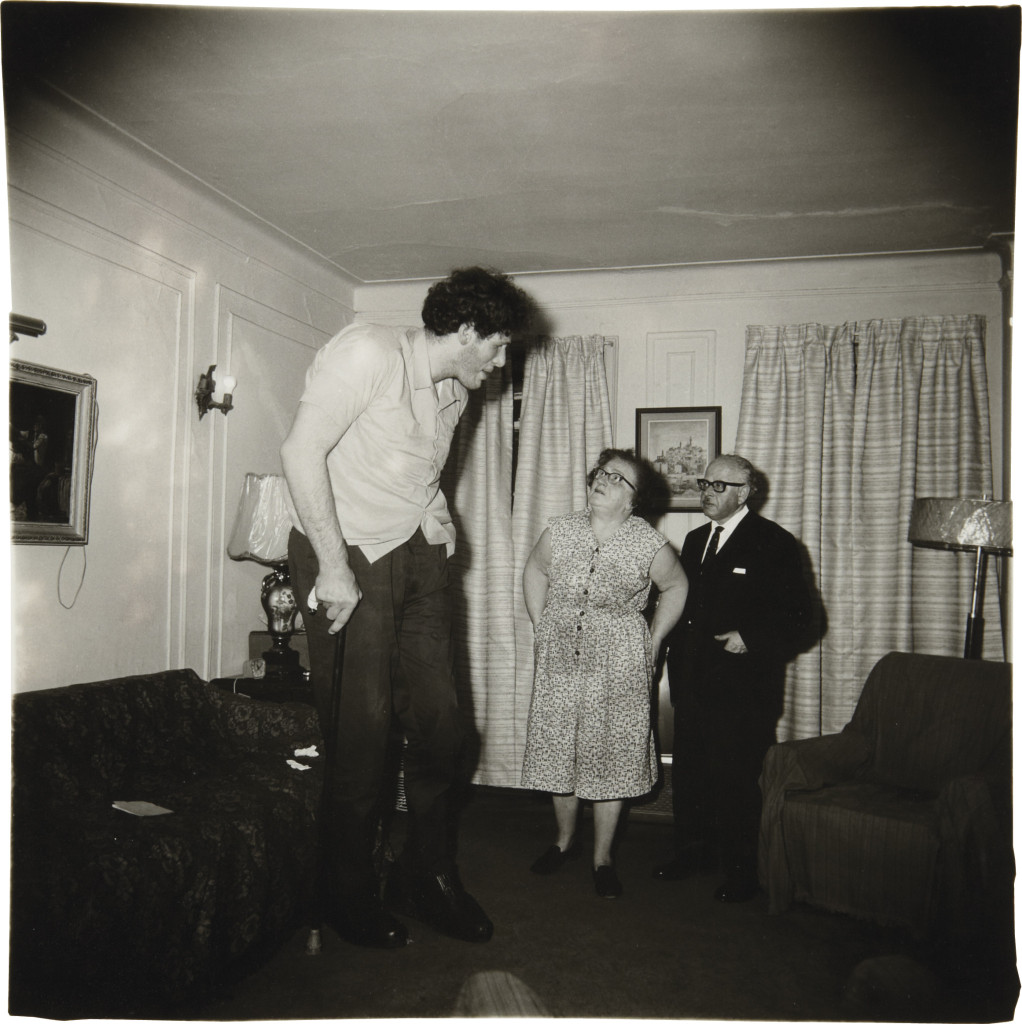 A Jewish giant at home with his parents in the Bronx, N.Y.